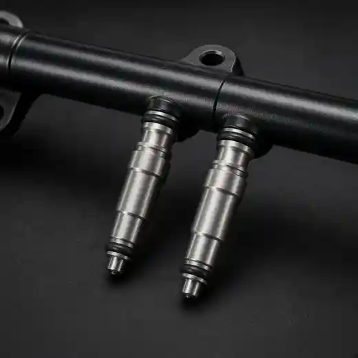 A fuel rail and injectors on a dark bench.